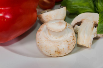 Parsley, lemon, pepper, champignons on a plate
