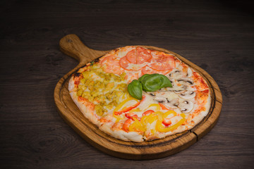 Hot piece of pizza with melted cheese on a rustic wooden table