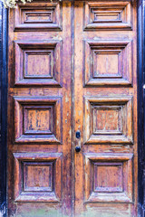 Closeup of old, worn antique wooden door with peeling paint