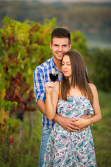 Young couple holding each other in vineyard outdoors