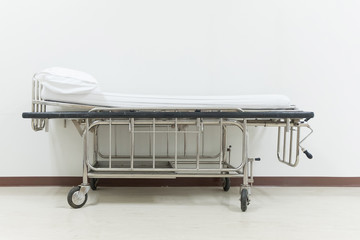Empty stretcher trolley or hospital trolley for patient with white room.
