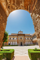 Fototapeta premium Palace of Alcazar, Famous Andalusian Architecture. Old Arab Palace in Seville, Spain. Ornamented Arch and Column. Famous travel destination.