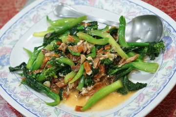 Stir fried chinese Kale with salted fish and dried squid. (With selective focus)