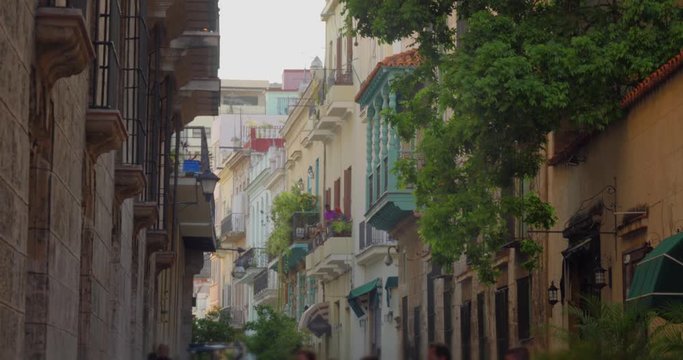 A daytime exterior establishing shots of the home and buildings lining the narrow streets of Havana, Cuba's old town district.  	