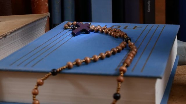 Wooden Rosary on the Bible. Zoom in.
