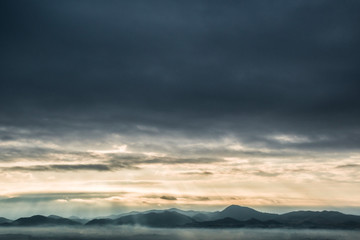 mountains landscape under morning sky with clouds.