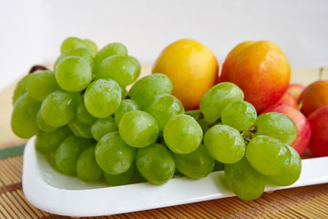 A bunch of white grapes on a white plate