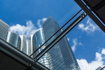 low angle view of high-rise buildings,seen through glass ceiling.