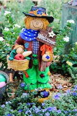 Close up image of a bright and cheerful garden scarecrow