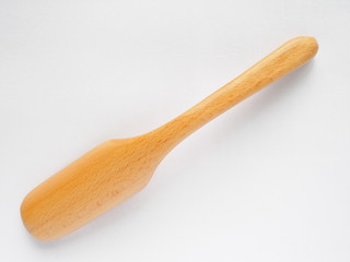 back side of beech wood spoon for making tea on white background