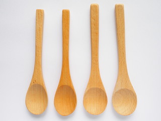 set of four beech wood  tea spoons on white background