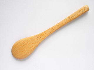back side of beech wood spoon on white background