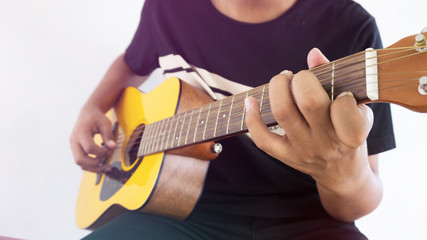 Fototapeta na wymiar A man playing acoustic guitar