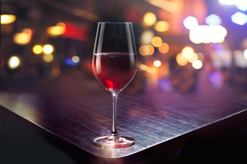 Wine glass on colorful bar background