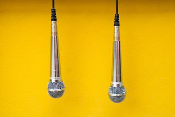 two microphone on yellow background