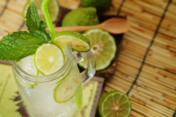 Kaffir lime So, Bergamot soda Cool drink, Thailand tradition Herb for Treatment of Acid Reflux, with Oriental Earth tone map background.Have some space for write wording