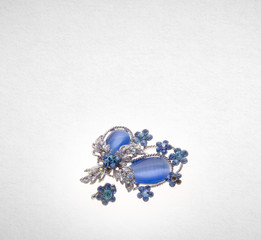 brooch with different gems on background.