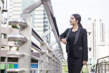 Young Beautiful Asian woman in city looking out and thinking about work. Young business woman with leader concept. White female thinking about business concept.