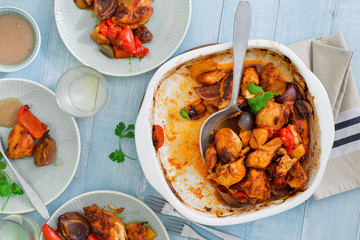 Baked chicken breast with vegetables on wooden table with wine