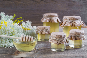 Group of glass jars with honey on  a rustic wooden background