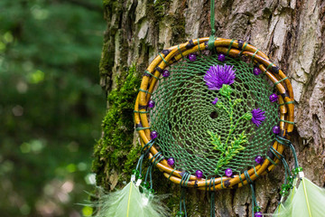 Dreamcatcher made of feathers, leather, beads, and ropes