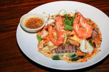 Rice topped with thick egg, Seafood Tomyum (Thai food).