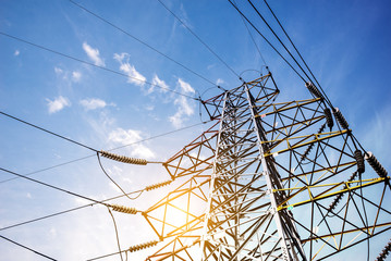 Electricity pylons at orange sunset