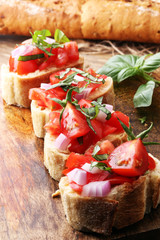 Bruschetta with tomatoes, herbs and oil on toasted garlic cheese bread toasted with chopped tomatoe