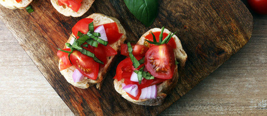 Bruschetta with tomatoes, herbs and oil on toasted garlic cheese bread toasted with chopped tomatoe