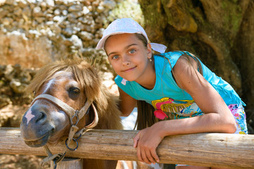 Girl and pony. A teenage girl next to a pony at the Zoo
