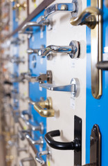 Stand with door handles in store