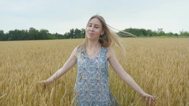 Girl Walking Through Wheat Field