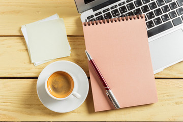 Office table background with coffee cup, pencils and computer keyboard. Business workplace or workspace concept.