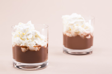 Two glasses of cocoa with whipped cream and marshmallows