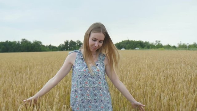 Beautiful Woman Walking Through Wheat Field