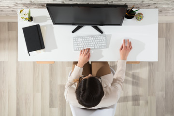 Woman Using Computer In Office
