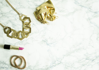 The women's accessories lie on the marble table