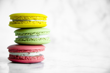 Colorful French macaroons on a marble table
