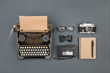 Journalist or private detective workplace - typewriter, camera, recorder and other stuff