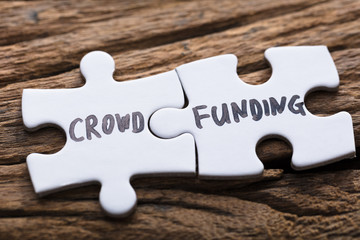 Closeup Of Connected Crowd Funding Jigsaw Pieces