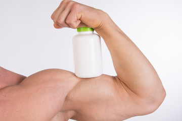 Sports nutrition and a healthy lifestyle. A man is holding a jar of pills. 