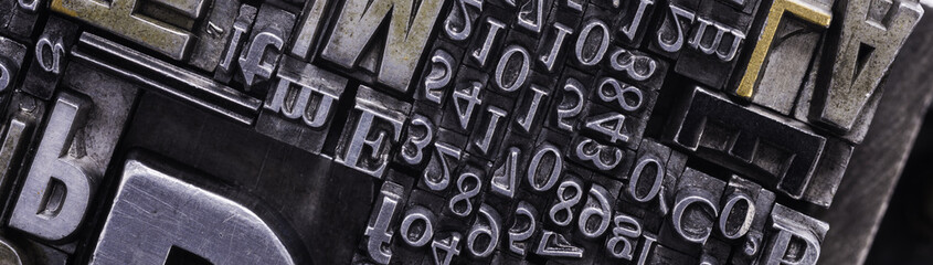 Metal Letterpress Types. A background from many historic typographical letters in black and white with white background.
