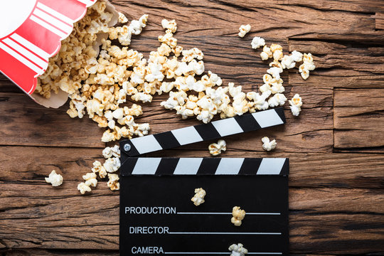 Clapperboard And Popcorn On Wood Representing Movie Time