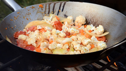 Camp food being cooked on a camp fire.