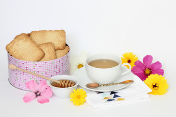 Tin of biscuits with tea and honey 