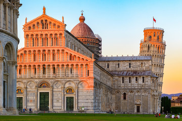 Golden sunlight hit on the top of the Leaning Tower and Pisa Cathedral in Italy - obrazy, fototapety, plakaty