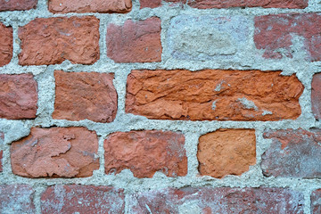 bright red brick in an old wall