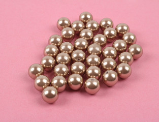 Pearls loose on colored backdrop