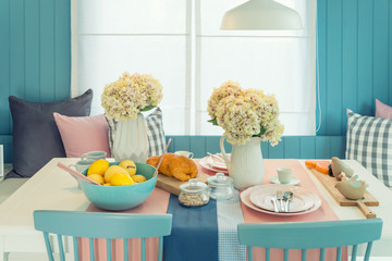 Wooden table and chair in vintage dinning room at home. Table set on dining table, interior design.
