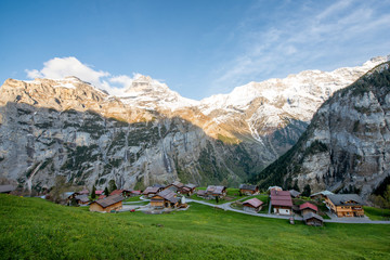 Farmhouse in village with swiss alps snow mountain in background in Grindelwald, Switzerland....